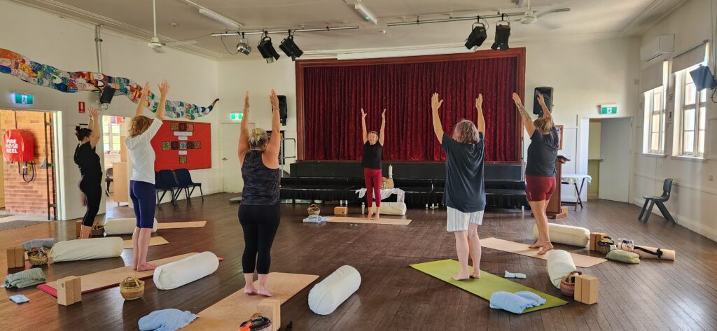 Extended Tadasana - women with arms above their head