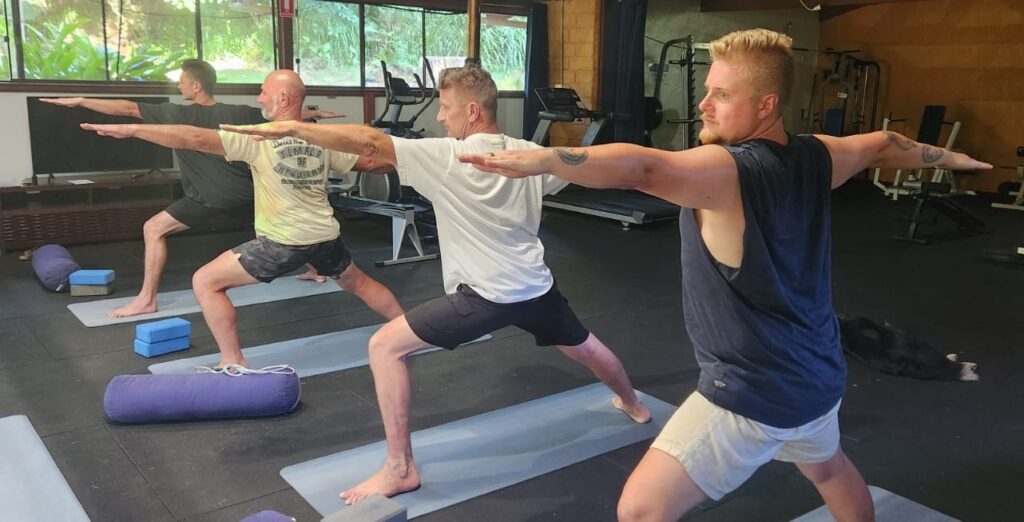 four men doing warrior pose