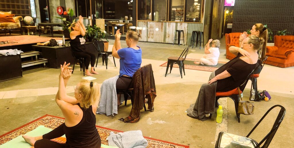 Chair & mat yoga with participants doing eagle arms