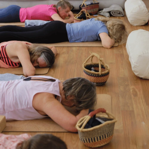 five women lying on mats 2